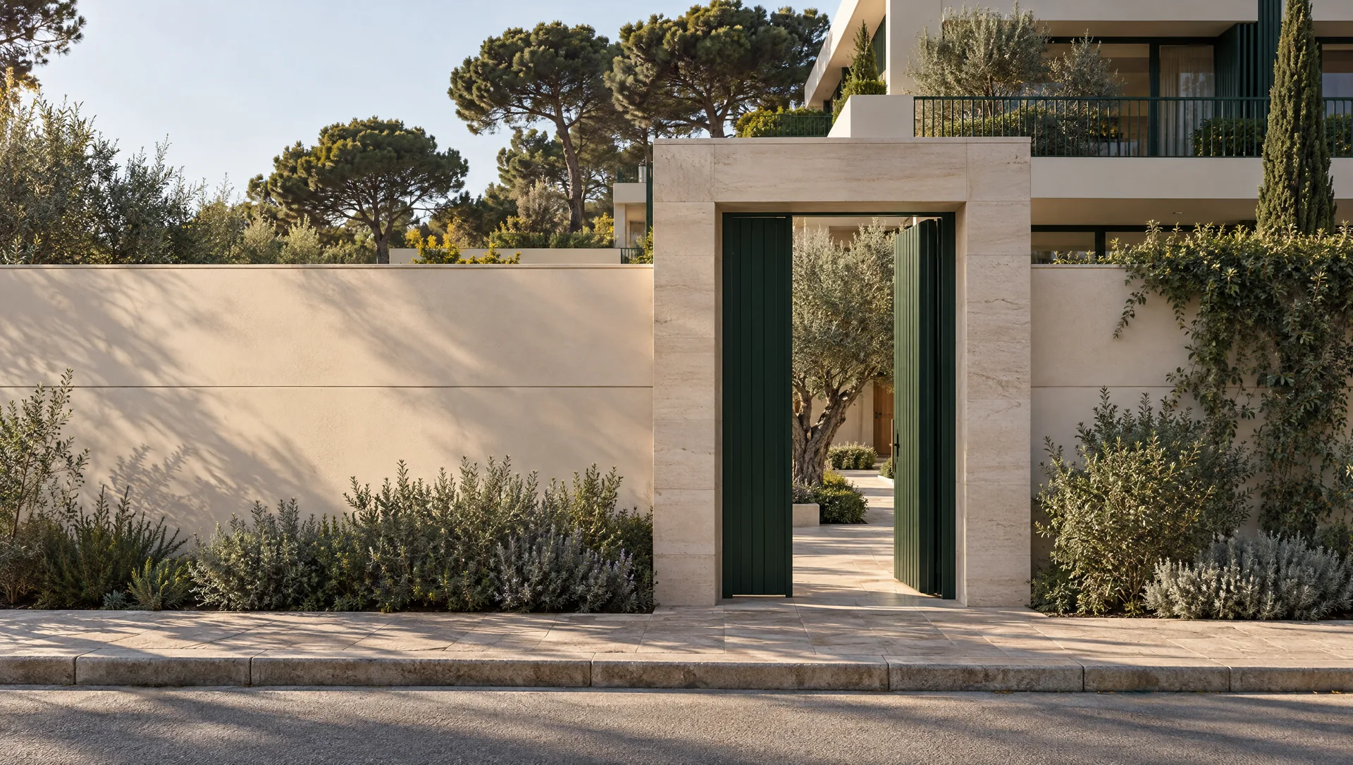 A limestone gate on a quiet street in Vouliagmeni, the start of a walk through a courtyard, a corridor and a home to the sea